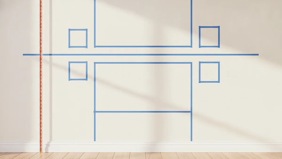 Tape layout plan on a wall with center line and marked frame positions