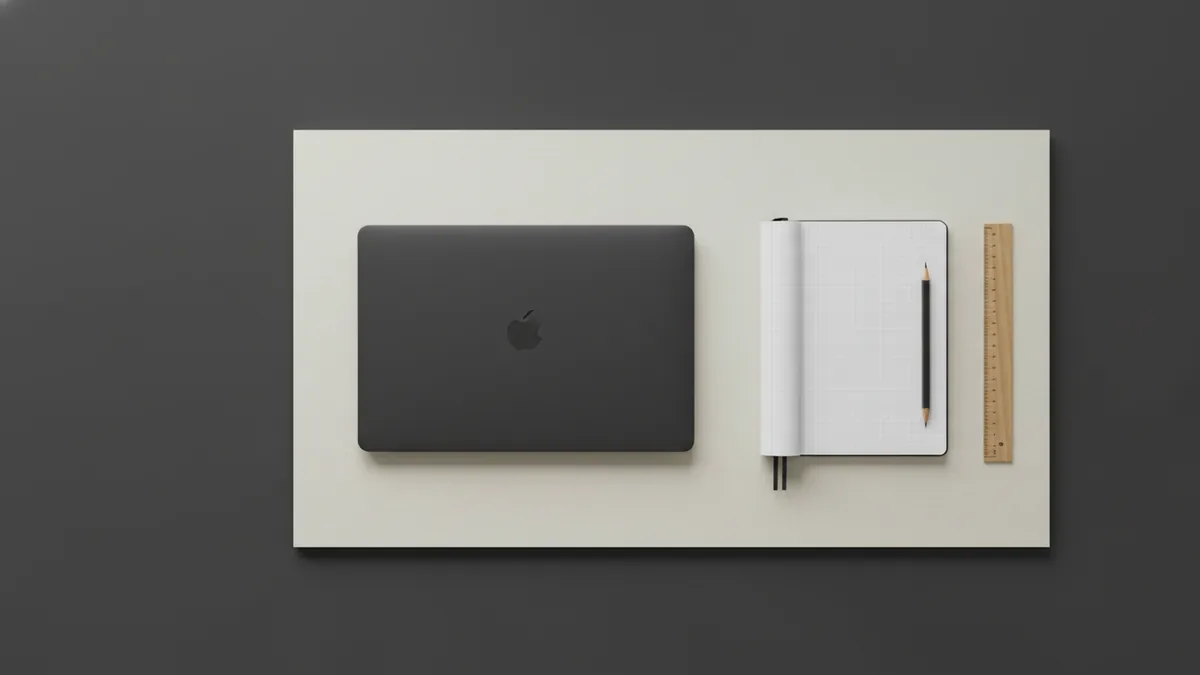 Laptop and notebook used to compare prices and measure bedroom furniture