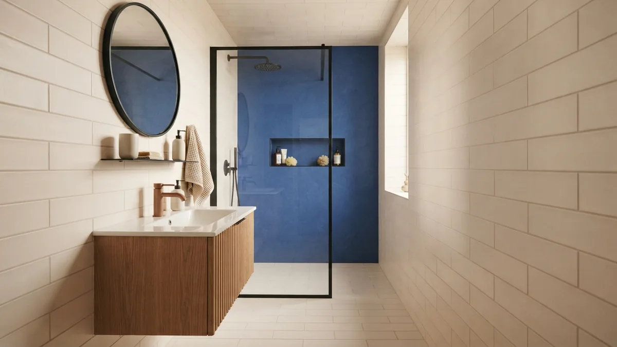 Tile layout changes room proportions Compact bathroom showing a horizontal rectangular tile layout and dark accent wall